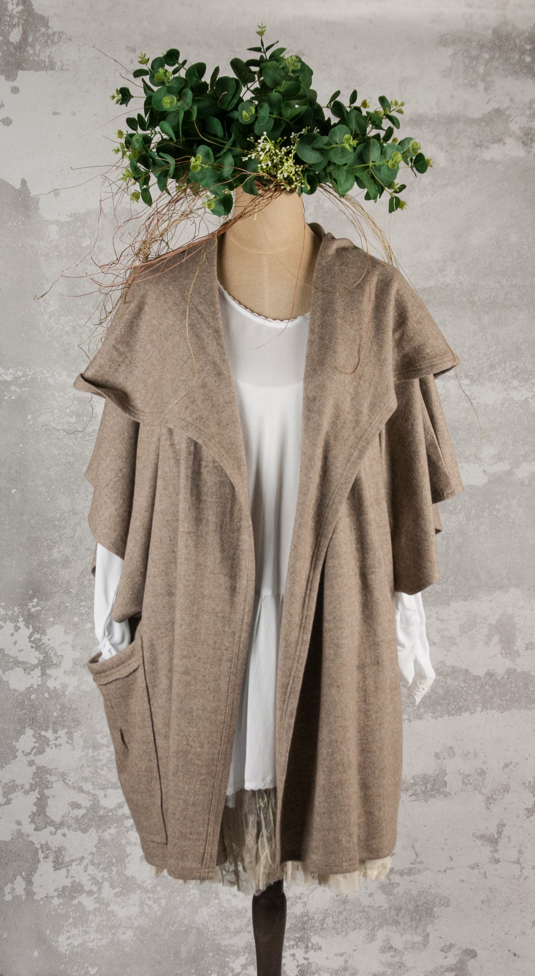 Hooded poncho over jacket